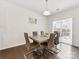 Bright dining room features modern table, contemporary chairs, stylish light fixture, and sliding glass door at 4261 Coachwhip Ave, Lancaster, SC 29720