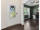 Bright foyer leading to an office featuring hardwood floors and a modern ceiling fan at 4261 Coachwhip Ave, Lancaster, SC 29720