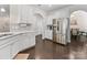 Open-concept kitchen with white cabinetry, stainless steel appliances, and hardwood floors at 4261 Coachwhip Ave, Lancaster, SC 29720