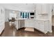 Open-concept kitchen with white cabinets, stainless steel appliances, and hardwood floors at 4261 Coachwhip Ave, Lancaster, SC 29720