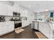 Bright kitchen with white cabinets, stainless steel appliances, and hardwood floors at 4261 Coachwhip Ave, Lancaster, SC 29720