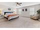 Bright main bedroom with ample natural light, a ceiling fan, and a decorative chair at 4261 Coachwhip Ave, Lancaster, SC 29720