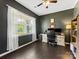 Comfortable home office with large window, dark walls, and hardwood floors at 4261 Coachwhip Ave, Lancaster, SC 29720