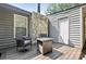 Cozy back deck featuring chairs, a small table, and a stone fireplace offering an outdoor living space at 432 English Ivy Ct, Fort Mill, SC 29715