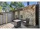 Back deck featuring a stone fireplace, chairs, and a small table offers an outdoor living space at 432 English Ivy Ct, Fort Mill, SC 29715
