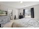 Bedroom with plush carpeting, neutral walls, a large window, a dresser and a gray bed at 432 English Ivy Ct, Fort Mill, SC 29715