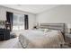 Bedroom with plush carpeting, neutral walls, a large window and a wooden bed frame at 432 English Ivy Ct, Fort Mill, SC 29715