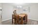 Dining area featuring a wood table with seating for six and modern light fixture at 432 English Ivy Ct, Fort Mill, SC 29715