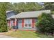 Inviting single-story home with red shutters, well-manicured lawn, and lovely landscaping at 432 English Ivy Ct, Fort Mill, SC 29715