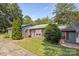 Inviting single-story home with red shutters, well-manicured lawn, and mature trees at 432 English Ivy Ct, Fort Mill, SC 29715