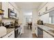Well-equipped kitchen with granite countertops, modern appliances, and open dining area view at 432 English Ivy Ct, Fort Mill, SC 29715