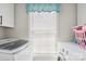 Functional laundry room with modern washer and dryer and natural light from the window at 432 English Ivy Ct, Fort Mill, SC 29715