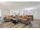 Spacious living room with stylish decor, connecting to kitchen and dining areas at 432 English Ivy Ct, Fort Mill, SC 29715