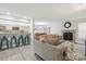 Open-concept living room with fireplace, view of kitchen, and dining area at 432 English Ivy Ct, Fort Mill, SC 29715