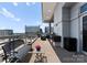 Condo balcony with outdoor seating and barbecue area, showcasing views of the city at 435 S Tryon St # 907, Charlotte, NC 28202