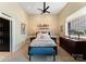 Comfortable bedroom with plush bedding, artwork, and a bright window view at 435 S Tryon St # 907, Charlotte, NC 28202