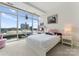 Bright bedroom with large windows offering city views and a cozy carpet at 435 S Tryon St # 907, Charlotte, NC 28202