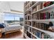 Bedroom with floor to ceiling view of the city and built-in bookshelves at 435 S Tryon St # 907, Charlotte, NC 28202
