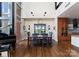 Dining area with modern furnishings and a piano, filled with natural light from large windows at 435 S Tryon St # 907, Charlotte, NC 28202