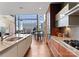 Stylish kitchen with stainless appliances and a grand piano within view, bathed in natural light at 435 S Tryon St # 907, Charlotte, NC 28202