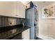 Compact laundry room with stackable washer and dryer at 435 S Tryon St # 907, Charlotte, NC 28202