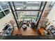 Open floorplan living room boasts floor to ceiling windows, hardwood floors, and grand piano at 435 S Tryon St # 907, Charlotte, NC 28202