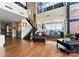 Spacious open-concept living room with hardwood floors, high ceilings, and large windows with city views at 435 S Tryon St # 907, Charlotte, NC 28202