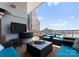 Outdoor patio with cozy seating area and a built-in grill with expansive city views at 435 S Tryon St # 907, Charlotte, NC 28202