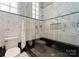 Sleek bathroom featuring marble tile, a glass-enclosed shower, and modern fixtures at 435 S Tryon St # 907, Charlotte, NC 28202