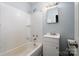 Modest bathroom with white fixtures, shower-tub combo and simple vanity with mirror at 4510 Wildwood Ave, Charlotte, NC 28208