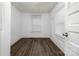 Simple bedroom with wood floors and two windows that allows for natural light to fill the room at 4510 Wildwood Ave, Charlotte, NC 28208