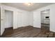 Bedroom featuring wood floors, access to a closet, and a view into another room at 4510 Wildwood Ave, Charlotte, NC 28208