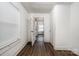 Bright hallway with wood floors, natural light from window, leading to the rest of the house at 4510 Wildwood Ave, Charlotte, NC 28208