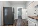 Functional kitchen with white cabinets, laminate countertops, and modern appliances at 4510 Wildwood Ave, Charlotte, NC 28208