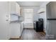 Functional kitchen with white cabinetry, laminate countertops, and essential appliances at 4510 Wildwood Ave, Charlotte, NC 28208