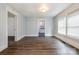 Spacious room featuring laminate wood flooring, natural light, and an open doorway at 4510 Wildwood Ave, Charlotte, NC 28208
