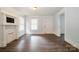 Bright living room featuring laminate wood flooring, light walls, and a faux fireplace at 4510 Wildwood Ave, Charlotte, NC 28208