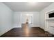 Bright living room featuring laminate wood flooring, light walls, and a decorative fireplace at 4510 Wildwood Ave, Charlotte, NC 28208
