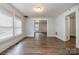 Open living room featuring wood floors, multiple windows with natural light, and neutral color palette at 4510 Wildwood Ave, Charlotte, NC 28208