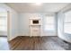 Bright living room featuring laminate wood flooring, light walls, and a faux fireplace at 4510 Wildwood Ave, Charlotte, NC 28208