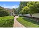 Professionally landscaped backyard featuring manicured lawn and mature trees at 4527 Hubbard Falls Dr, Charlotte, NC 28269