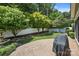 Backyard with patio area, mature trees, and a privacy fence at 4527 Hubbard Falls Dr, Charlotte, NC 28269