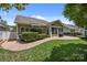 Backyard with a stone patio, lush green grass, and manicured landscaping at 4527 Hubbard Falls Dr, Charlotte, NC 28269