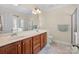 Bathroom featuring a double sink vanity and shower with glass door at 4527 Hubbard Falls Dr, Charlotte, NC 28269