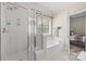 Bathroom featuring a glass-enclosed shower and a soaking tub at 4527 Hubbard Falls Dr, Charlotte, NC 28269