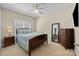 Comfortable bedroom with a ceiling fan, featuring neutral walls and a serene ambiance at 4527 Hubbard Falls Dr, Charlotte, NC 28269