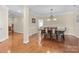 Spacious dining room featuring hardwood floors and classic lighting, ideal for Gathering gatherings and entertaining at 4527 Hubbard Falls Dr, Charlotte, NC 28269