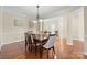 Bright dining room featuring hardwood floors and classic lighting, creating a warm and inviting atmosphere at 4527 Hubbard Falls Dr, Charlotte, NC 28269