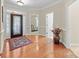 Bright foyer with hardwood floors, showcasing the home's inviting entrance and open layout at 4527 Hubbard Falls Dr, Charlotte, NC 28269