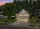Charming single-Gathering home with a manicured lawn, mature trees, and a two-car garage at 4527 Hubbard Falls Dr, Charlotte, NC 28269